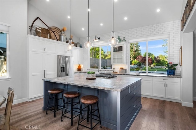 2244 N 1st Ave, Upland, CA 91784 - kitchen with appliances with stainless steel finishes, backsplash, white cabinets, a kitchen island, and recessed lighting