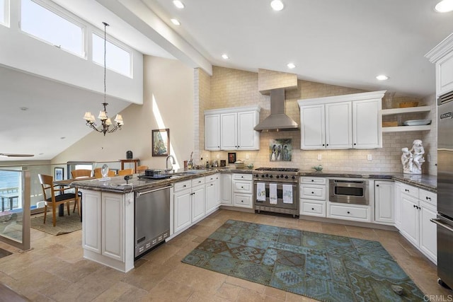 1744 Tattenham Rd, Encinitas, CA 92024 - kitchen featuring stainless steel appliances, wall chimney exhaust hood, a chandelier, tasteful backsplash, and a peninsula