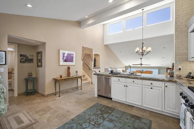 1744 Tattenham Rd, Encinitas, CA 92024 - kitchen featuring a sink, appliances with stainless steel finishes, stone tile floors, white cabinets, and a chandelier