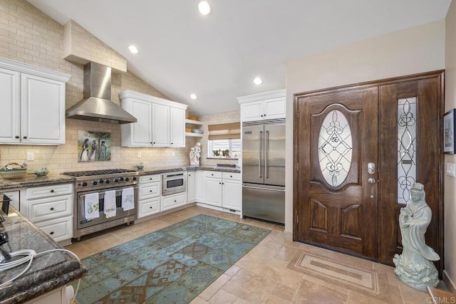 1744 Tattenham Rd, Encinitas, CA 92024 - kitchen featuring premium appliances, wall chimney range hood, lofted ceiling, decorative backsplash, and white cabinetry