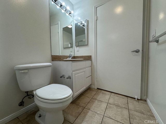 7551 Jordan Ave Unit 410, Canoga Park, CA 91303 - bathroom featuring toilet, vanity, tile patterned floors, and baseboards