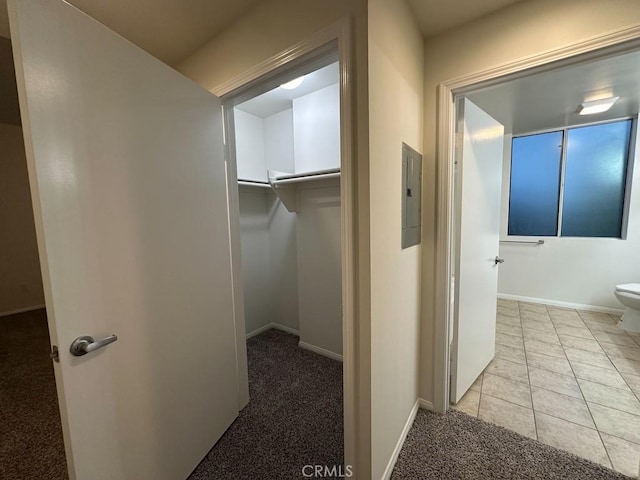 7551 Jordan Ave Unit 410, Canoga Park, CA 91303 - corridor with electric panel, carpet flooring, baseboards, and tile patterned flooring