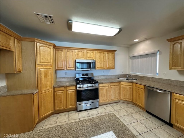 7551 Jordan Ave Unit 410, Canoga Park, CA 91303 - kitchen featuring stainless steel appliances, a sink, and light tile patterned floors