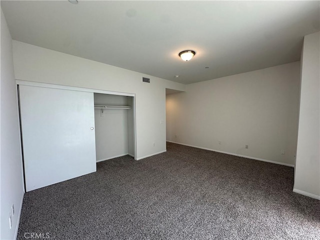 7551 Jordan Ave Unit 410, Canoga Park, CA 91303 - unfurnished bedroom with dark colored carpet, a closet, and baseboards