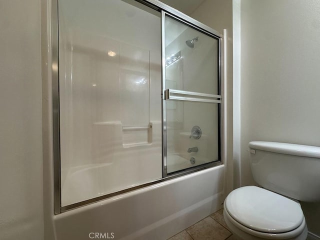 7551 Jordan Ave Unit 410, Canoga Park, CA 91303 - bathroom featuring shower / bath combination with glass door, toilet, and tile patterned flooring