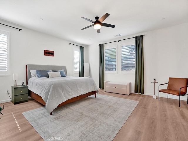 8967 Sunshine Valley Way, Corona, CA 92883 - bedroom with light wood finished floors, baseboards, and ceiling fan