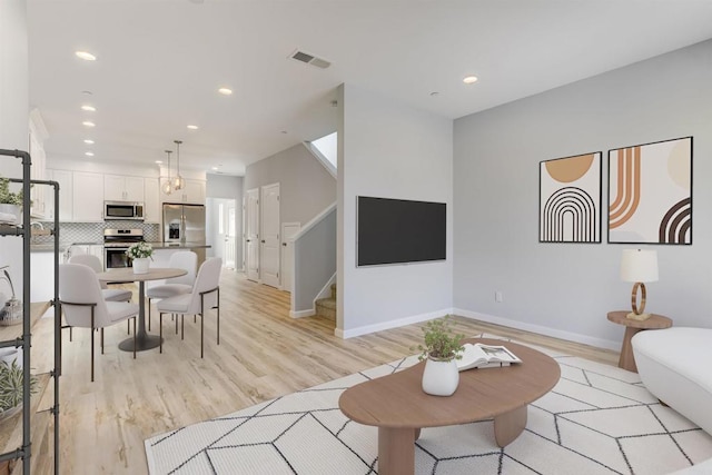 535 60th St, San Diego, CA 92114 - living area featuring stairs, light wood-style flooring, recessed lighting, and baseboards