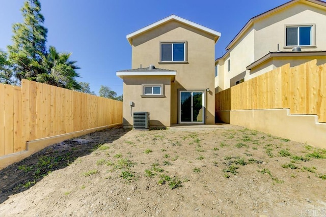 535 60th St, San Diego, CA 92114 - rear view of house with stucco siding, a fenced backyard, and cooling unit