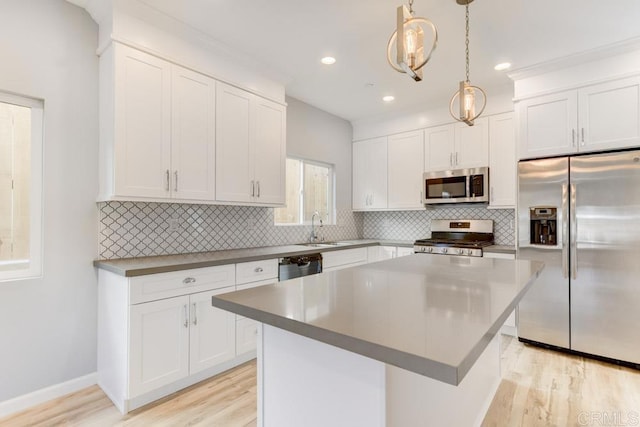 535 60th St, San Diego, CA 92114 - kitchen with appliances with stainless steel finishes, light wood finished floors, white cabinetry, tasteful backsplash, and recessed lighting
