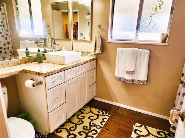 2772 E 2nd St Unit E2, Long Beach, CA 90803 - bathroom featuring baseboards, vanity, wood finished floors, and toilet