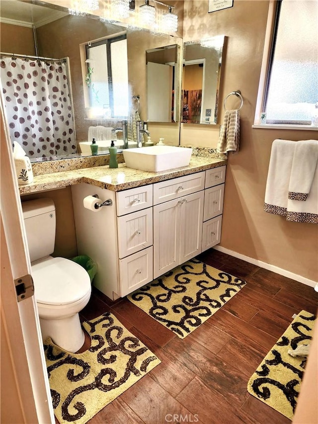 2772 E 2nd St Unit E2, Long Beach, CA 90803 - full bathroom with toilet, wood finished floors, vanity, baseboards, and crown molding