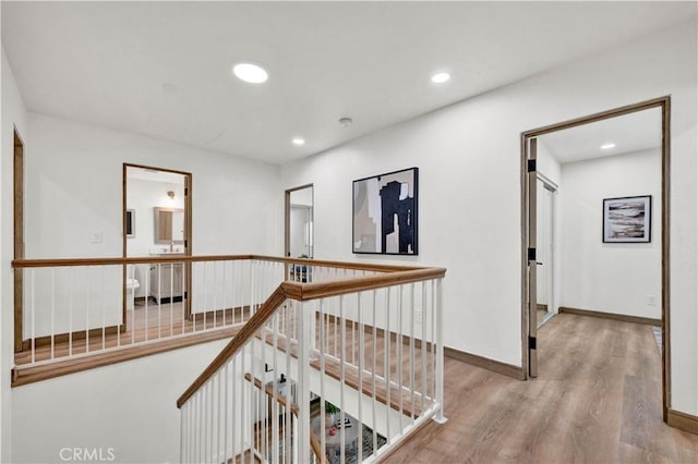 921 Dahlia Ave, Costa Mesa, CA 92626 - hall with wood finished floors, recessed lighting, an upstairs landing, and baseboards