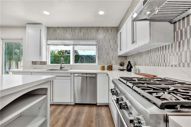 921 Dahlia Ave, Costa Mesa, CA 92626 - kitchen featuring stainless steel appliances, a sink, under cabinet range hood, white cabinetry, and recessed lighting