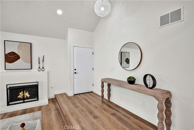 921 Dahlia Ave, Costa Mesa, CA 92626 - foyer featuring lofted ceiling, wood finished floors, a lit fireplace, baseboards, and recessed lighting