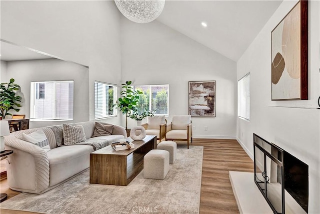 921 Dahlia Ave, Costa Mesa, CA 92626 - living area featuring high vaulted ceiling, healthy amount of natural light, wood finished floors, baseboards, and recessed lighting