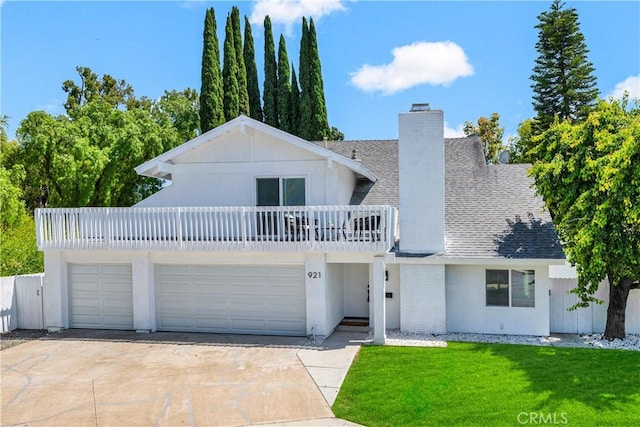 921 Dahlia Ave, Costa Mesa, CA 92626 - view of front facade featuring a chimney, driveway, roof with shingles, a front yard, and a balcony