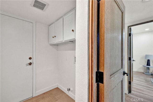921 Dahlia Ave, Costa Mesa, CA 92626 - laundry room with cabinet space, baseboards, and light wood-type flooring