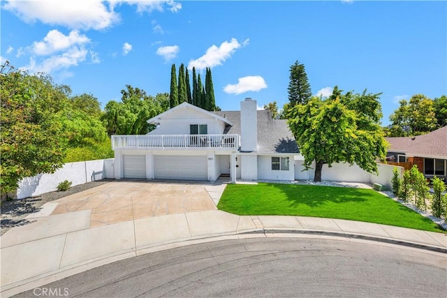 921 Dahlia Ave, Costa Mesa, CA 92626 - view of front of house with a garage, a front lawn, driveway, a chimney, and stucco siding
