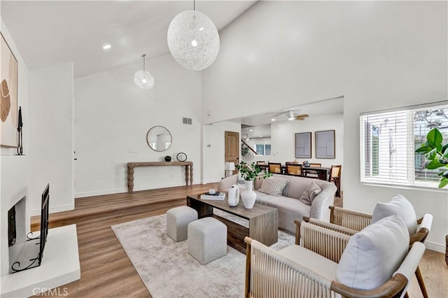 921 Dahlia Ave, Costa Mesa, CA 92626 - living area featuring ceiling fan, light wood-type flooring, high vaulted ceiling, and baseboards