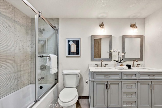 921 Dahlia Ave, Costa Mesa, CA 92626 - bathroom featuring bath / shower combo with glass door, toilet, double vanity, and baseboards