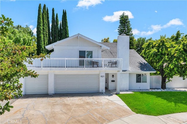 921 Dahlia Ave, Costa Mesa, CA 92626 - view of front facade with a balcony, a chimney, concrete driveway, a front lawn, and roof with shingles