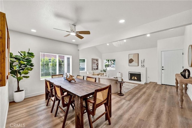 921 Dahlia Ave, Costa Mesa, CA 92626 - dining space with a ceiling fan, light wood-type flooring, recessed lighting, baseboards, and a warm lit fireplace