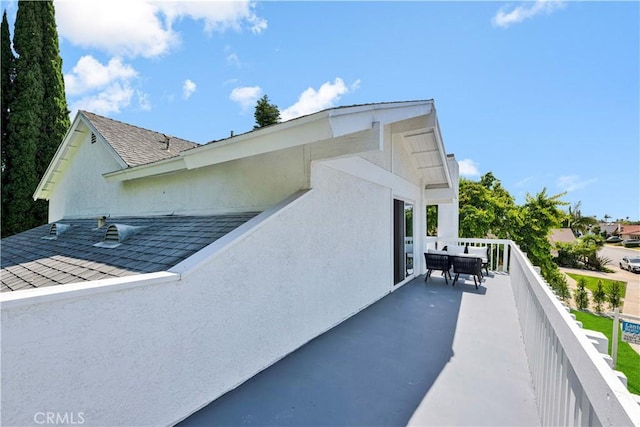 921 Dahlia Ave, Costa Mesa, CA 92626 - view of side of property featuring roof with shingles, stucco siding, and outdoor dining space