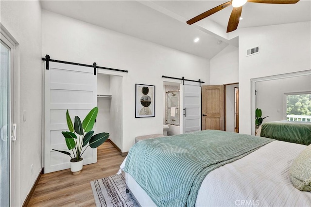 921 Dahlia Ave, Costa Mesa, CA 92626 - bedroom with a barn door, light wood-style flooring, beam ceiling, baseboards, and high vaulted ceiling