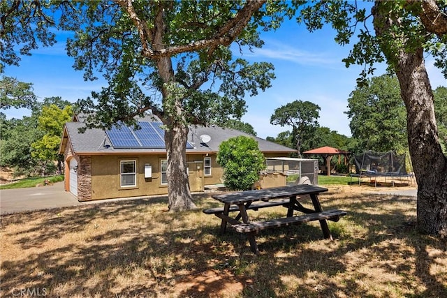 14690 Paynes Creek Rd, Red Bluff, CA 96080 - view of yard featuring a trampoline, driveway, and an attached garage