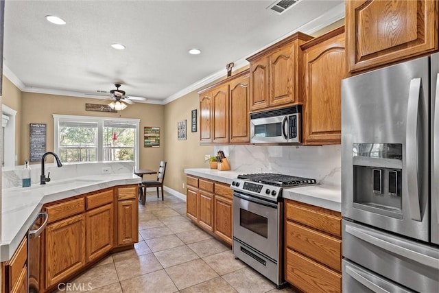 14690 Paynes Creek Rd, Red Bluff, CA 96080 - kitchen featuring stainless steel appliances, a sink, crown molding, light countertops, and ceiling fan