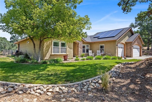 14690 Paynes Creek Rd, Red Bluff, CA 96080 - view of front of home with stucco siding, an attached garage, solar panels, and a front lawn