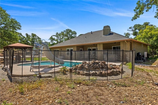 14690 Paynes Creek Rd, Red Bluff, CA 96080 - view of pool featuring a gazebo, a water slide, a patio area, and an outdoor fire pit