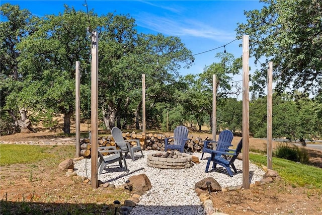 14690 Paynes Creek Rd, Red Bluff, CA 96080 - view of patio / terrace featuring a fire pit and view of wooded area