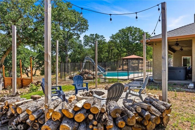 14690 Paynes Creek Rd, Red Bluff, CA 96080 - view of yard with an outdoor fire pit, a gazebo, ceiling fan, a hot tub, and a patio