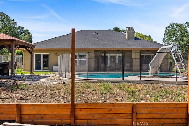 14690 Paynes Creek Rd, Red Bluff, CA 96080 - rear view of property featuring a gazebo, a chimney, stucco siding, and roof with shingles