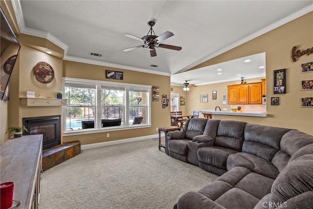 14690 Paynes Creek Rd, Red Bluff, CA 96080 - carpeted living room with a ceiling fan, crown molding, lofted ceiling, a glass covered fireplace, and recessed lighting