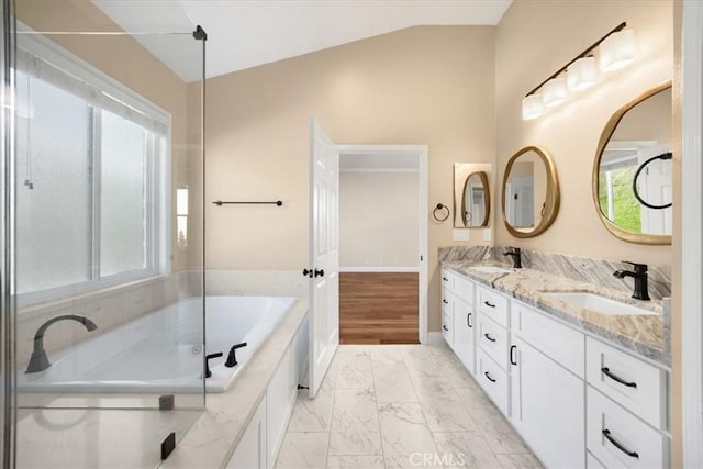 5420 Kodiak Mountain Dr, Yorba Linda, CA 92887 - bathroom featuring marble look tile flooring, vaulted ceiling, double vanity, a garden tub, and baseboards