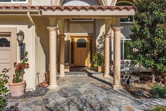 5420 Kodiak Mountain Dr, Yorba Linda, CA 92887 - view of exterior entry featuring stucco siding, a tiled roof, and a porch