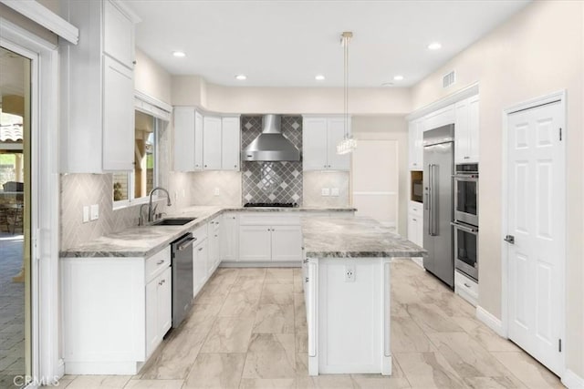 5420 Kodiak Mountain Dr, Yorba Linda, CA 92887 - kitchen with wall chimney exhaust hood, appliances with stainless steel finishes, white cabinetry, a kitchen island, and light stone counters