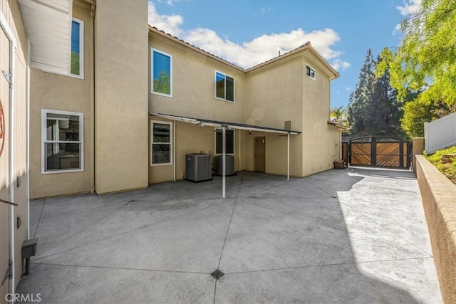 5420 Kodiak Mountain Dr, Yorba Linda, CA 92887 - rear view of property featuring a gate, central AC unit, stucco siding, and a patio