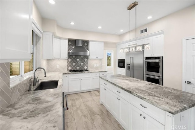5420 Kodiak Mountain Dr, Yorba Linda, CA 92887 - kitchen with appliances with stainless steel finishes, wall chimney range hood, a sink, a kitchen island, and tasteful backsplash