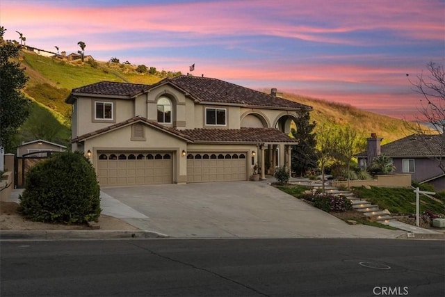 5420 Kodiak Mountain Dr, Yorba Linda, CA 92887 - mediterranean / spanish-style home with driveway, stucco siding, a tile roof, and an attached garage