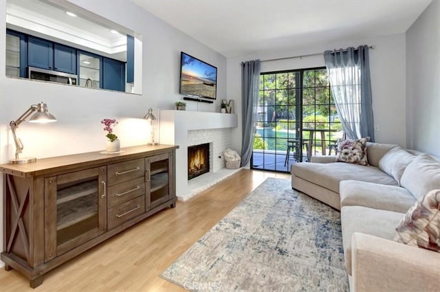 20122 Bayfront Ln Unit 102, Huntington Beach, CA 92646 - living room with light wood-style floors and a fireplace
