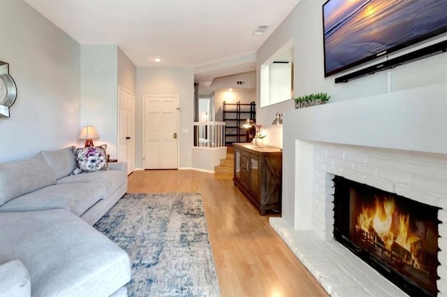 20122 Bayfront Ln Unit 102, Huntington Beach, CA 92646 - living room with light wood finished floors and a fireplace