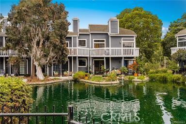 20122 Bayfront Ln Unit 102, Huntington Beach, CA 92646 - rear view of house featuring a water view
