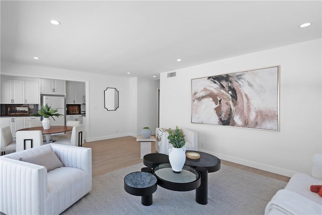 1524 Franklin St Unit C, Santa Monica, CA 90404 - living room with light wood-style floors, recessed lighting, radiator, and baseboards