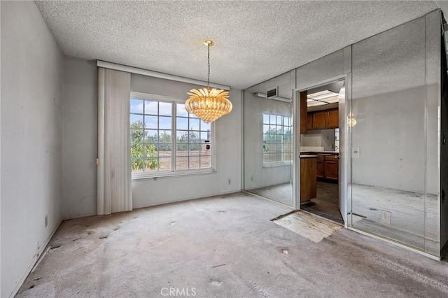1945 Cumberland Dr, West Covina, CA 91792 - unfurnished dining area featuring healthy amount of natural light, light carpet, a chandelier, and a textured ceiling