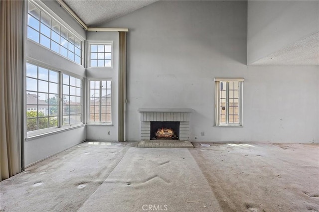 1945 Cumberland Dr, West Covina, CA 91792 - unfurnished living room with high vaulted ceiling, a textured ceiling, carpet, plenty of natural light, and a brick fireplace