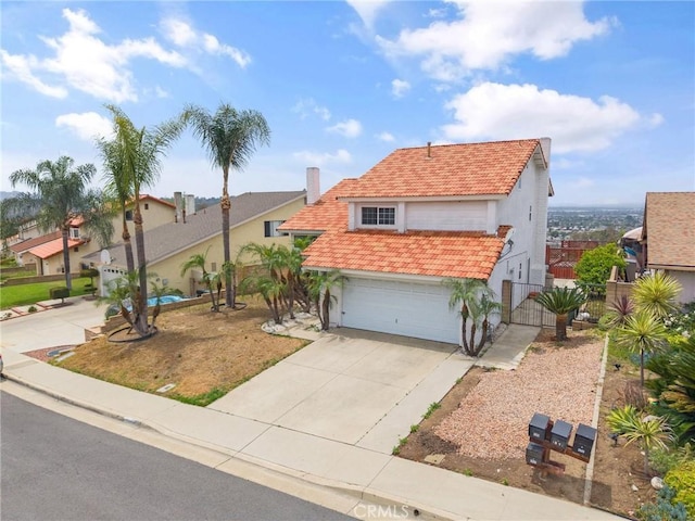 1945 Cumberland Dr, West Covina, CA 91792 - view of front facade with stucco siding, a gate, an attached garage, concrete driveway, and a tiled roof