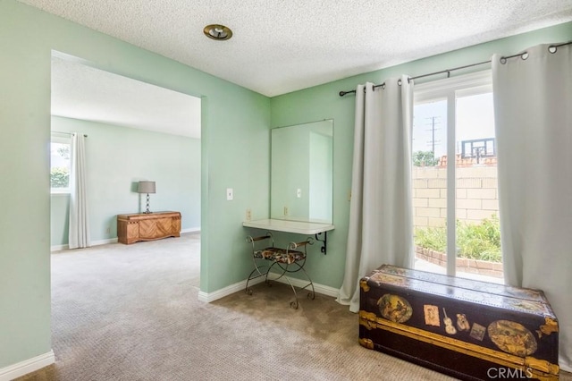 4734 E Tanglewood Ave, Anaheim, CA 92807 - hallway with healthy amount of natural light, carpet floors, a textured ceiling, and baseboards